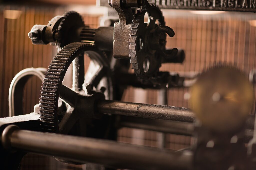 Iron cogs on old weaving machine in textile mill