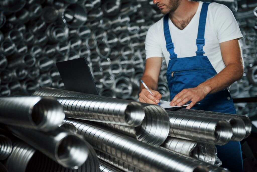 Particle view. Man in uniform works on the production. Industrial modern technology