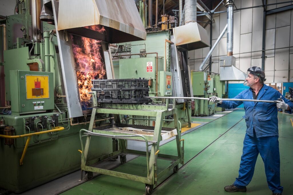 Engineer heat treating gear wheels in engineering factory