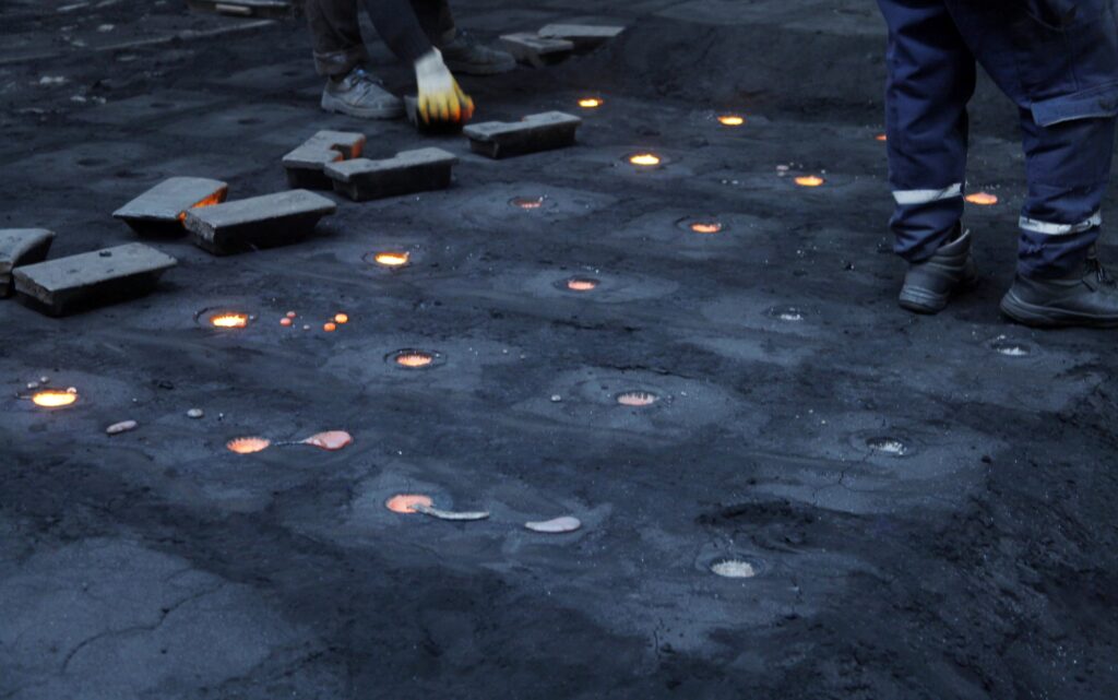 Steel factory. Liquid metal in molds.