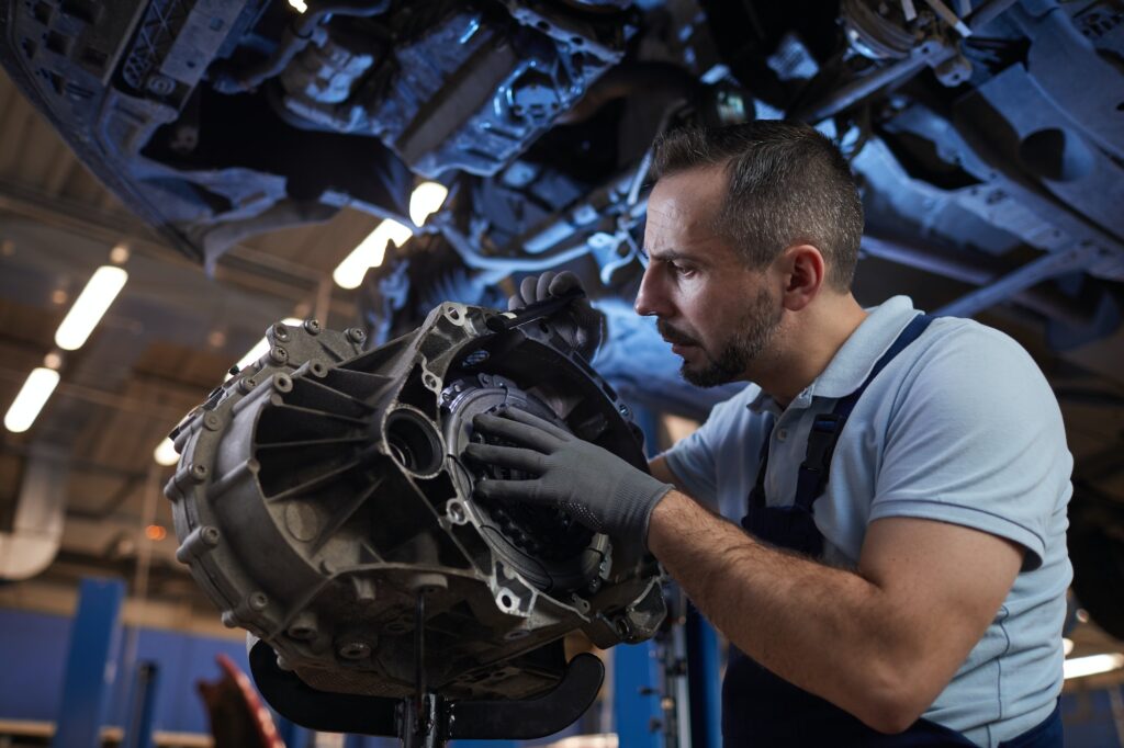 Auto Mechanic Fixing Car on Lift