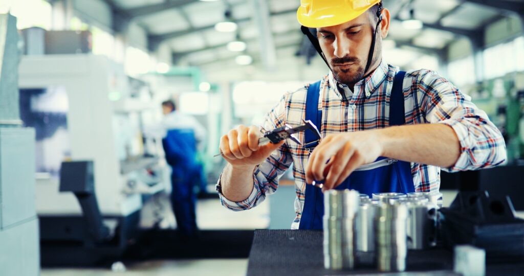 Male worker and quality control inspection in factory