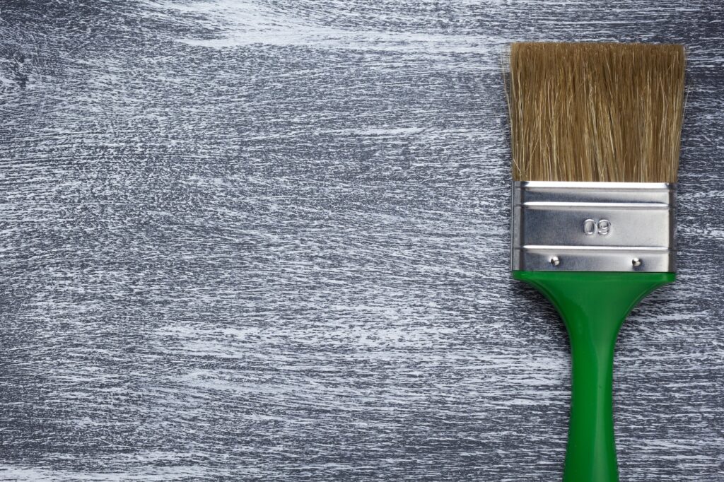 paint brush on wooden painted background