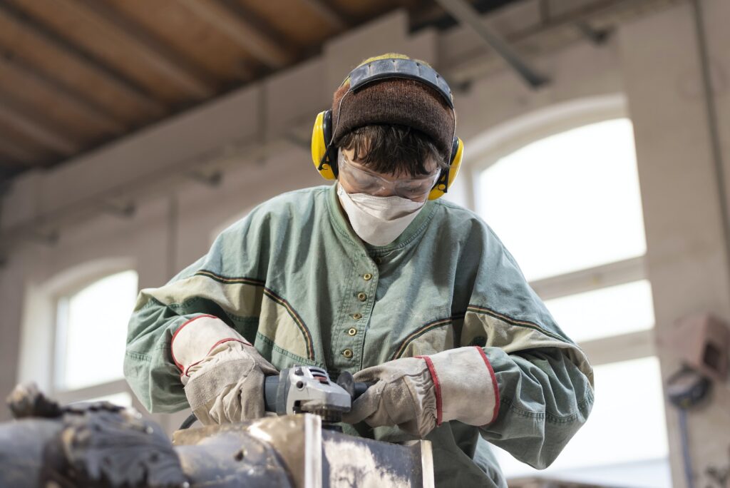 Art foundry, Female foundry worker polishing metal