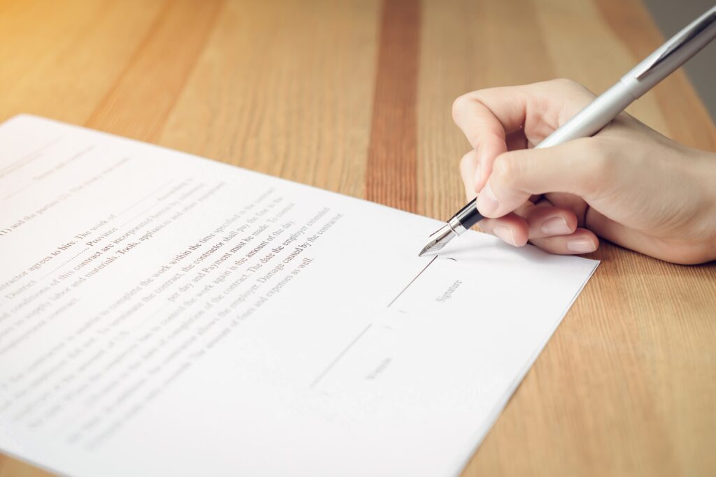 closeup of signing a documentation agreement and pen on the table.