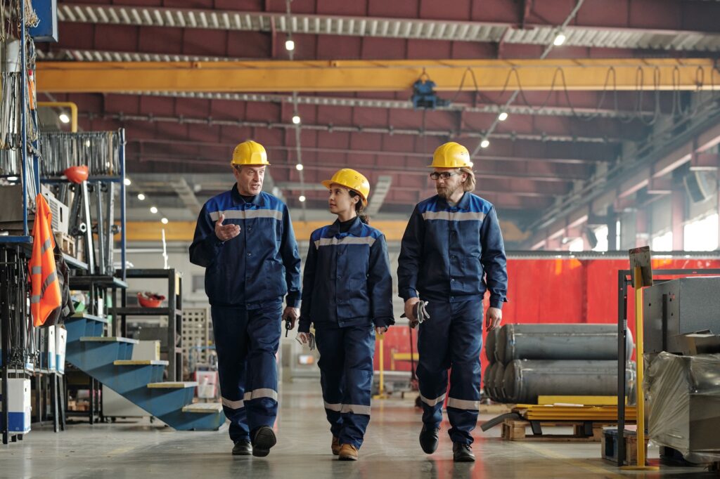 Factory foreman explaining tasks to employees