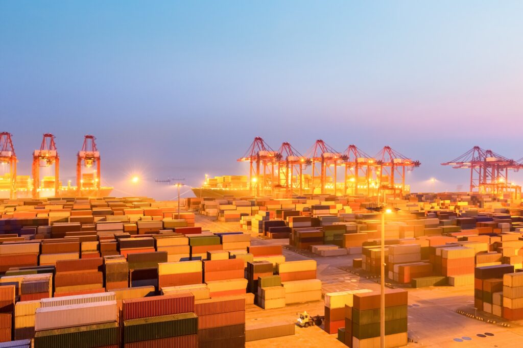 container wharf in nightfall, international import and export trade background