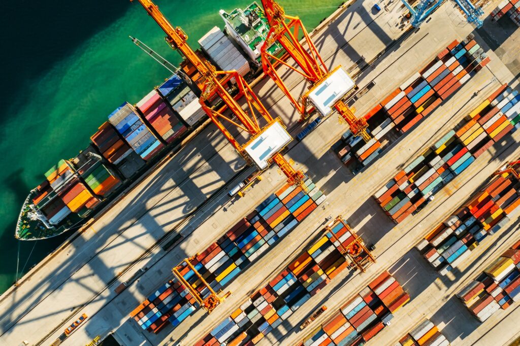 Containers in international shipping dock waiting to import or export and transportation. Top view