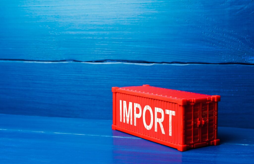 Red cargo ship container with word IMPORT.